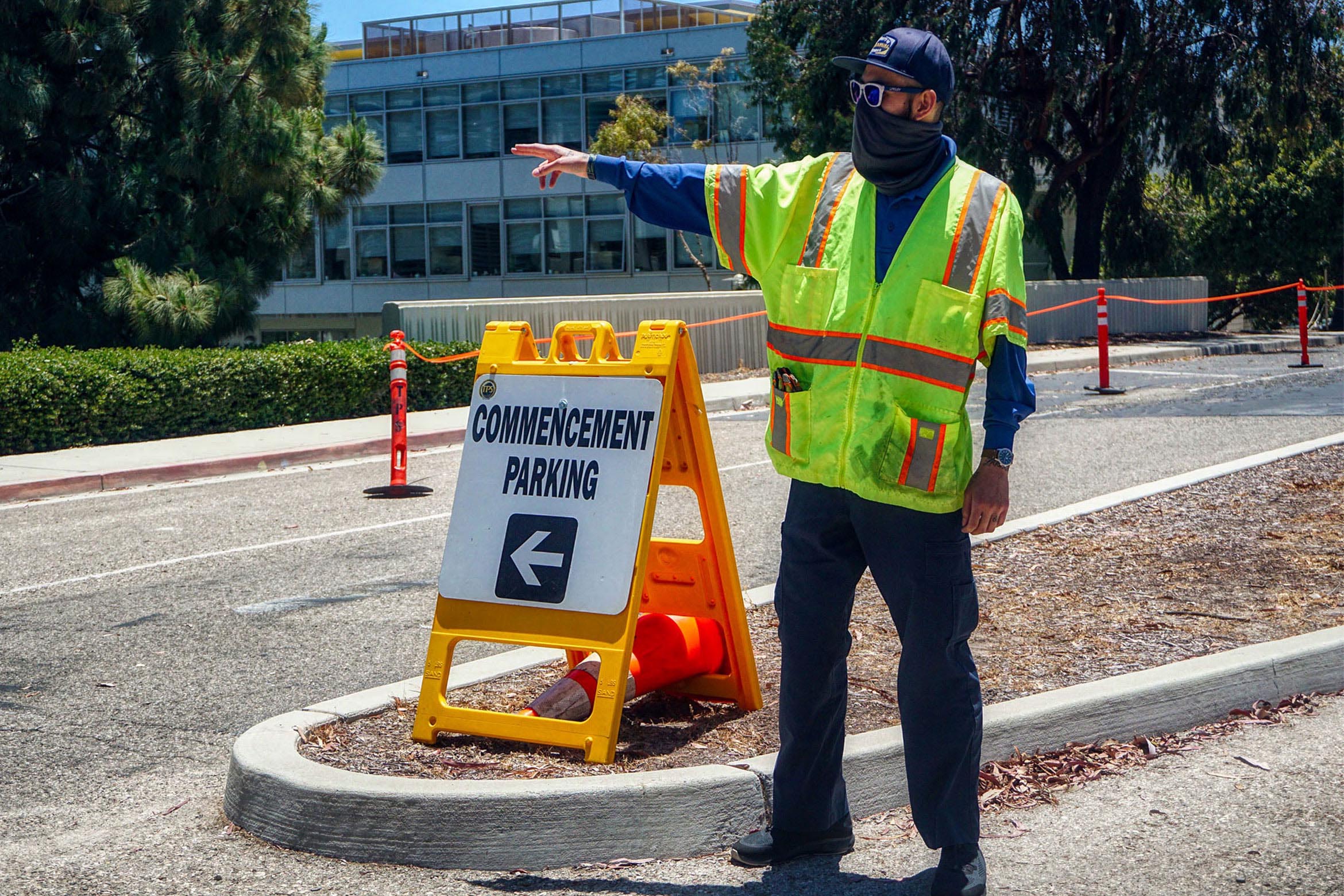 TPS worker directing traffic at graduation