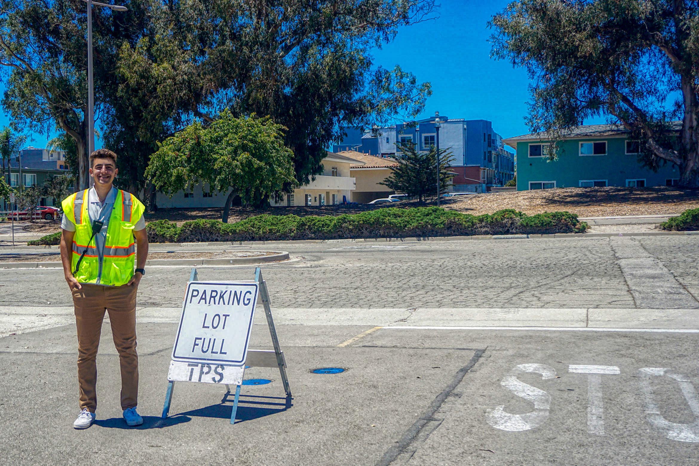 TPS worker standing next to a lot full sign